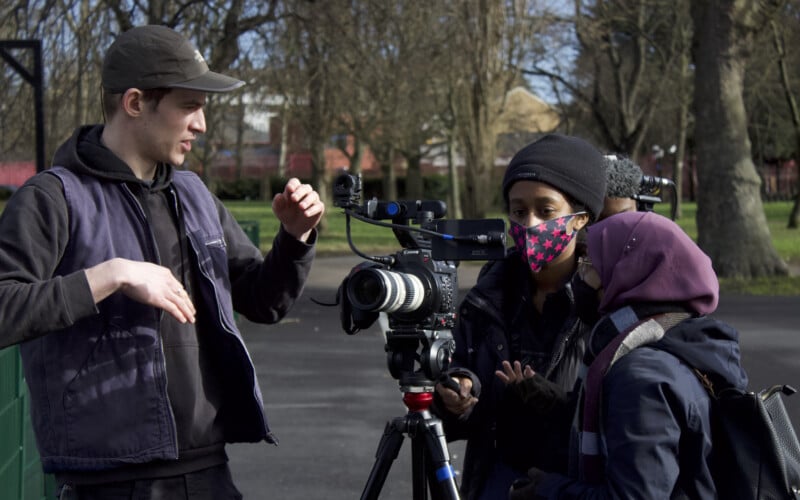 Chocolate Films Cameraman showing two people how to use a video camera