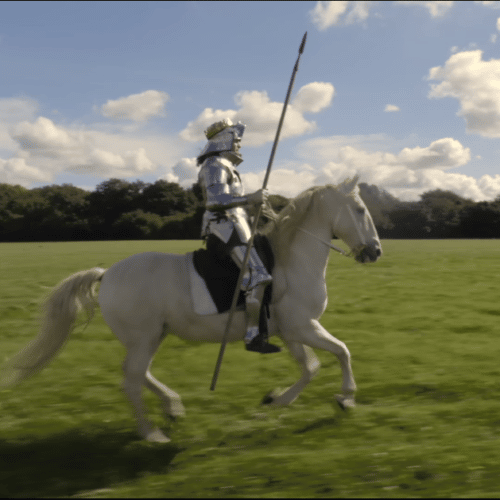 Knight riding a white horse across a field to advertise Jeep