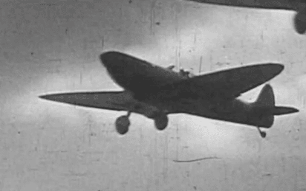 Black and White Photograph of a flying plane from underneath at the Biggin Hill Museum