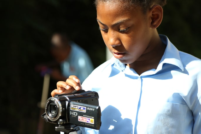 Young person uses camcorder