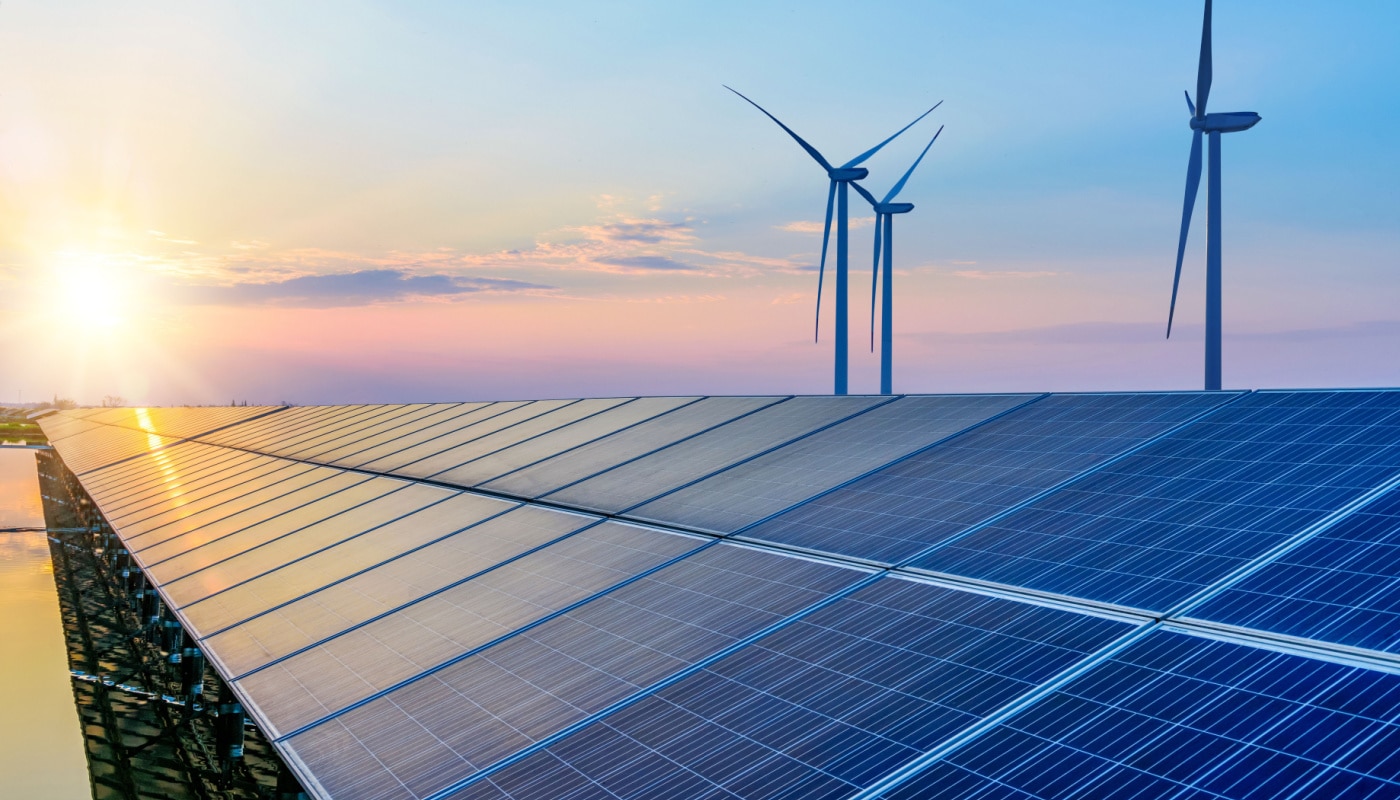 A landscape with solar panels and wind turbines